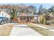 Charming home with a well-maintained lawn, cozy porch, and private driveway for off-street parking at 20 S Eugenia Nw Pl, Atlanta, GA 30318