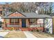 Inviting home exterior featuring a cozy porch, fresh paint, and mature landscaping in front yard at 20 S Eugenia Nw Pl, Atlanta, GA 30318