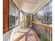 Outdoor view of deck featuring stained wood floor, black metal railings, and tree views beyond at 20 S Eugenia Nw Pl, Atlanta, GA 30318
