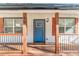 Charming front porch with a vibrant blue door and craftsman-style wooden supports and shutters at 20 S Eugenia Nw Pl, Atlanta, GA 30318