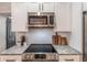 Close up on kitchen with stainless steel appliances, granite countertops, and white cabinets at 20 S Eugenia Nw Pl, Atlanta, GA 30318