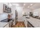 Modern kitchen boasts stainless appliances, granite counters, an island and eat in breakfast bar at 20 S Eugenia Nw Pl, Atlanta, GA 30318