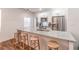 Bright kitchen boasts stainless appliances, granite counters and an island with seating at 20 S Eugenia Nw Pl, Atlanta, GA 30318