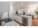 Stylish kitchen island with stainless steel dishwasher and view of dining area at 20 S Eugenia Nw Pl, Atlanta, GA 30318