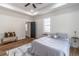 Bedroom features tray ceiling, wood floors, and ensuite bath at 20 S Eugenia Nw Pl, Atlanta, GA 30318