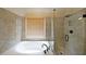 Close up of a bathroom with a glass-enclosed shower and a large soaking tub at 2747 Harper Woods Dr, Marietta, GA 30062