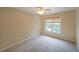 Cozy bedroom featuring a ceiling fan, plush carpet, and a large window at 2747 Harper Woods Dr, Marietta, GA 30062