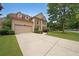 Two-story home featuring a two-car garage, stone accents, and a well-kept front lawn at 2747 Harper Woods Dr, Marietta, GA 30062