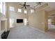 Spacious living room with tall ceilings, large windows, a ceiling fan, and plush carpeting at 2747 Harper Woods Dr, Marietta, GA 30062