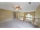 Second-story loft featuring wood railing, plush carpet, and neutral walls at 2747 Harper Woods Dr, Marietta, GA 30062