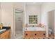Spacious bathroom with separate shower and soaking tub with a window at 3113 Brians Creek Se Dr, Conyers, GA 30013