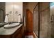 Bathroom featuring a large, framed glass shower, decorative mirror, and wooden storage cabinet at 3155 Wills Mill Rd, Cumming, GA 30041