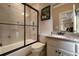 Bright bathroom featuring a tub-shower combo, granite vanity, and tile flooring at 3155 Wills Mill Rd, Cumming, GA 30041