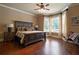 Spacious bedroom with hardwood floors, ceiling fan and many windows that provides plenty of natural light at 3155 Wills Mill Rd, Cumming, GA 30041