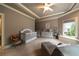 Bedroom with a crib, soft chair, and decor accents creating a calm atmosphere at 3155 Wills Mill Rd, Cumming, GA 30041