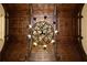 A rustic chandelier hangs from a stained wood beamed ceiling, enhancing the home's architectural detail at 3155 Wills Mill Rd, Cumming, GA 30041