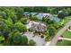 Aerial view of clubhouse and pool nestled in a community with mature trees and lush landscaping at 3155 Wills Mill Rd, Cumming, GA 30041