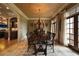 Elegant dining room with textured wallpaper, designer chandelier, and views of the backyard at 3155 Wills Mill Rd, Cumming, GA 30041
