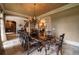 Elegant dining room with textured wallpaper, designer chandelier, and views of the backyard at 3155 Wills Mill Rd, Cumming, GA 30041