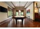 A game room with a pool table, television, and hardwood floors at 3155 Wills Mill Rd, Cumming, GA 30041