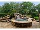 Inviting backyard hot tub with waterfall feature, surrounded by lush landscaping at 3155 Wills Mill Rd, Cumming, GA 30041