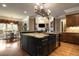 Spacious kitchen with island seating, granite countertops, and stainless steel appliances at 3155 Wills Mill Rd, Cumming, GA 30041