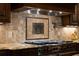 A chef's kitchen is showcased with a professional range and custom tile backsplash, ready for gourmet creations at 3155 Wills Mill Rd, Cumming, GA 30041