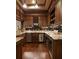 A kitchen with wooden cabinets, granite countertops, and stainless steel appliances at 3155 Wills Mill Rd, Cumming, GA 30041