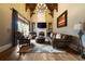 The living room boasts high ceilings, a stone fireplace, and plush seating, creating a cozy and grand space at 3155 Wills Mill Rd, Cumming, GA 30041