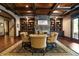 Comfortable living room with beamed ceilings, built-in shelving, and a cozy stone fireplace at 3155 Wills Mill Rd, Cumming, GA 30041