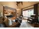 A large living room shows an open floor plan with a kitchen, leather furniture and large bright windows at 3155 Wills Mill Rd, Cumming, GA 30041