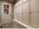Well-organized mudroom features custom cabinetry, drawers, seating, and access to the home's exterior at 3155 Wills Mill Rd, Cumming, GA 30041