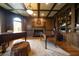 Wood-paneled office featuring a fireplace, custom bookshelves, and a grand piano at 3155 Wills Mill Rd, Cumming, GA 30041