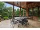 Inviting outdoor dining area with wrought iron table and lush views at 3155 Wills Mill Rd, Cumming, GA 30041