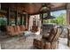Inviting outdoor kitchen and living area with seating and ceiling fans for relaxed entertainment at 3155 Wills Mill Rd, Cumming, GA 30041