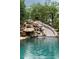 Stunning waterfall, slide, and pool create a backyard paradise at 3155 Wills Mill Rd, Cumming, GA 30041
