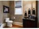The powder room features a decorative mirror, custom vanity, and elegant fixtures, perfect for guests at 3155 Wills Mill Rd, Cumming, GA 30041