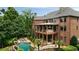 Stunning rear exterior view of a brick home featuring a pool and outdoor living spaces at 3155 Wills Mill Rd, Cumming, GA 30041