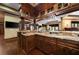 A bar with a granite countertop, dark wood cabinets, twisted columns and room for seating at 3155 Wills Mill Rd, Cumming, GA 30041