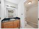 Bright bathroom with granite counters, shower-tub combo, and tile floor at 514 Mcgill Ne Pl, Atlanta, GA 30312