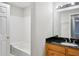 Bathroom featuring a tub with white tile and a wood vanity with a dark countertop at 514 Mcgill Ne Pl, Atlanta, GA 30312