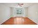 Bedroom with wood-look floors and a bay window, featuring a ceiling fan and light neutral walls at 514 Mcgill Ne Pl, Atlanta, GA 30312