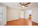 Bedroom with wood-look floors and a window, featuring a ceiling fan and two doors at 514 Mcgill Ne Pl, Atlanta, GA 30312