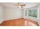 Bedroom with wood-look floors and a bay window, featuring a ceiling fan and light neutral walls at 514 Mcgill Ne Pl, Atlanta, GA 30312