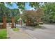 Brick and iron gate to the 350 McGill Place community with mature trees and professional landscaping at 514 Mcgill Ne Pl, Atlanta, GA 30312