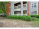 Exterior view showcases a patio, green hedges, and multi-story condo building at 514 Mcgill Ne Pl, Atlanta, GA 30312