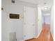 Hallway with wood-look floors leading into the home, featuring a coat rack and white walls at 514 Mcgill Ne Pl, Atlanta, GA 30312