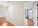 Hallway with wood-look floors leading into a bedroom, featuring a ceiling fan and lots of natural light at 514 Mcgill Ne Pl, Atlanta, GA 30312