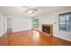 Spacious living room with wood floors, a brick fireplace, ceiling fan, and access to the balcony at 514 Mcgill Ne Pl, Atlanta, GA 30312