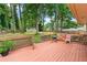 Fenced backyard featuring a wooden deck, grill, and a shed beyond the lawn at 564 Allana Ct, Stone Mountain, GA 30087